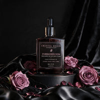 Actual Crystal Reign Forbidden Vow 50 mL fragrance oil bottle with mauve roses on black satin